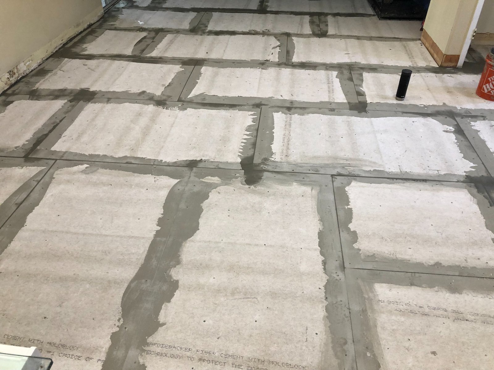 Prepared floor substrate and treated seams before large-format tile installation